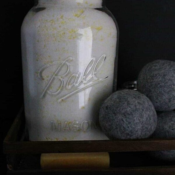 An oversized mason jar filled with homemade laundry detergent.